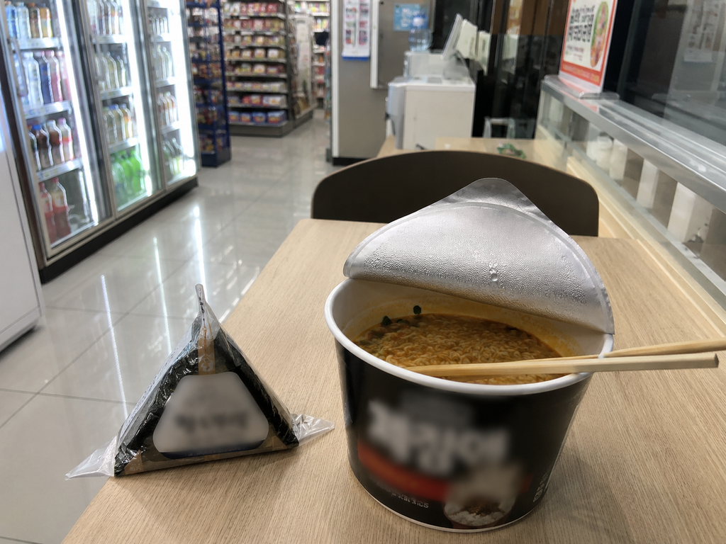 Cup ramyeon and triangle kimbap at a Korean convenience store