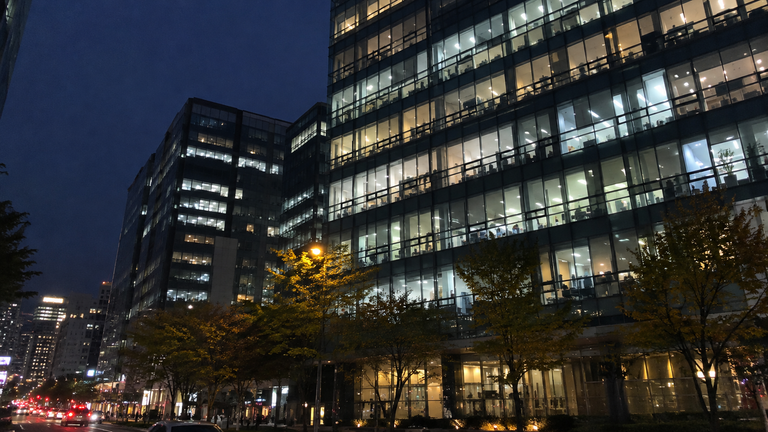 Office building in Seoul with lights still on after work hours