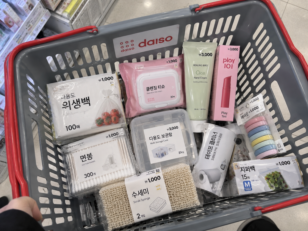 Everyday household supplies and cosmetics in a Daiso shopping basket
